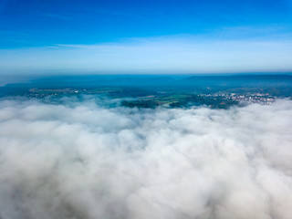 Landscape over the morning fog and low clouds and under the blue sky - drone and aerial photography