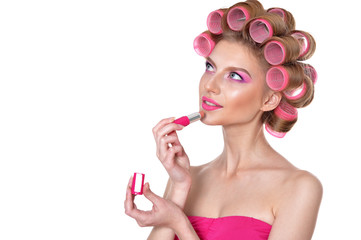 Beautiful woman with hair curlers with lipstick 