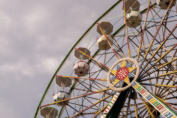 Ferris wheel on cloudy sky