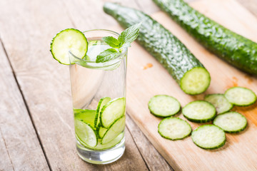 Cucumber summer cool water. Fresh cucumber slices and a glass of cucumber water
