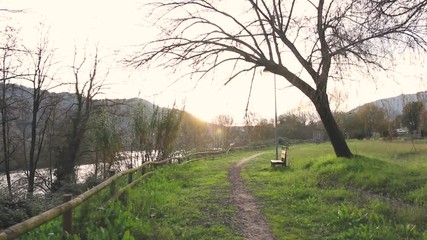 PATHWAY IN A PARK WITH SETTLE AND TREE