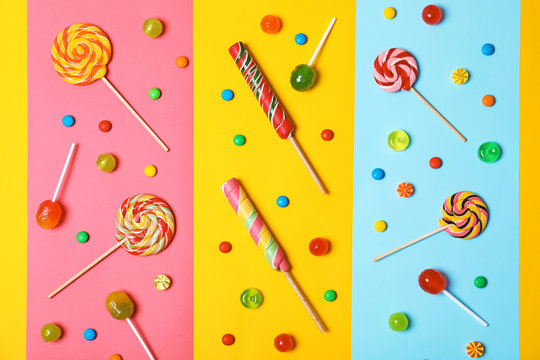 Flat lay composition with different tasty candies on color background