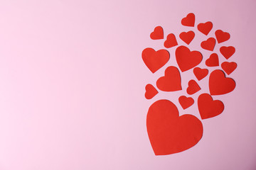 Paper hearts and space for text on color background, top view
