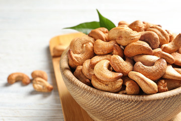 Bowl with cashew nuts on table, closeup