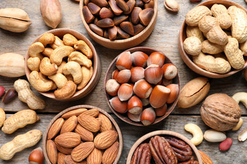 Flat lay composition with organic nuts on wooden background, top view. Snack mix