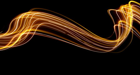Long exposure light painting photography, curvy lines of vibrant neon metallic yellow gold against...
