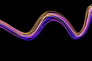 Long exposure light painting photography, curvy swirl of vibrant neon pink and metallic yellow gold against a black background