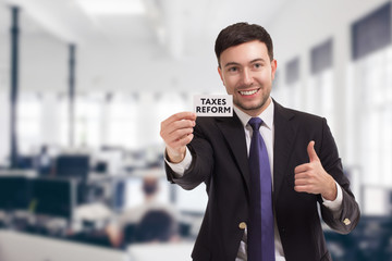Fototapeta premium Business, technology, internet and networking concept. Young entrepreneur showing keyword: taxes reform