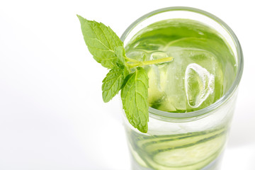 Closeup of fresh cucumber with ice cubes in a glass