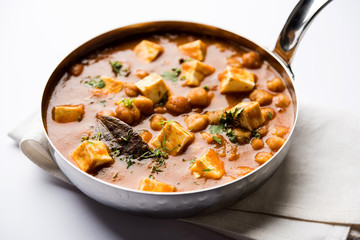 Chole Paneer curry made using boiled chickpea with cottage cheese with spices. Popular North Indian recipe. served in a bowl or serving pan. Selective focus