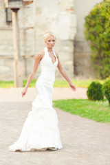 Fototapeta na wymiar Bride blonde in a luxurious wedding dress