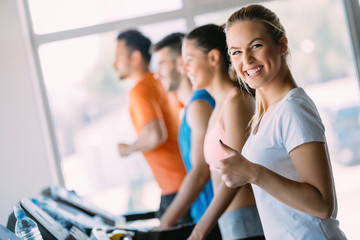 Fototapeta na wymiar Young attractive woman doing cardio training in gym
