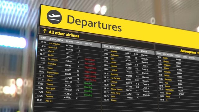 Airport departure board with updating flight information, transportation, travel. Destinations, flight status, boarding gates info change on screen