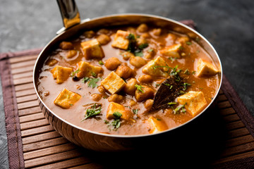 Chole Paneer curry made using boiled chickpea with cottage cheese with spices. Popular North Indian recipe. served in a bowl or serving pan. Selective focus