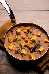 Chole Paneer curry made using boiled chickpea with cottage cheese with spices. Popular North Indian recipe. served in a bowl or serving pan. Selective focus