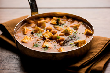 Chole Paneer curry made using boiled chickpea with cottage cheese with spices. Popular North Indian recipe. served in a bowl or serving pan. Selective focus