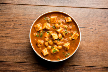 Chole Paneer curry made using boiled chickpea with cottage cheese with spices. Popular North Indian recipe. served in a bowl or serving pan. Selective focus