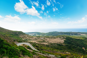 Fototapeta na wymiar Winding road on a green hill in Sardinia