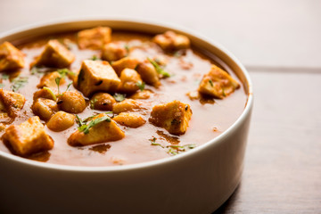 Chole Paneer curry made using boiled chickpea with cottage cheese with spices. Popular North Indian recipe. served in a bowl or serving pan. Selective focus