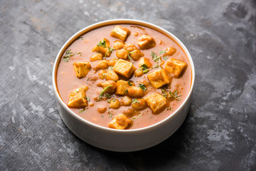 Chole Paneer curry made using boiled chickpea with cottage cheese with spices. Popular North Indian recipe. served in a bowl or serving pan. Selective focus