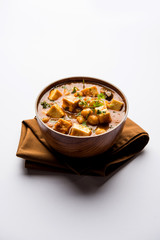 Chole Paneer curry made using boiled chickpea with cottage cheese with spices. Popular North Indian recipe. served in a bowl or serving pan. Selective focus