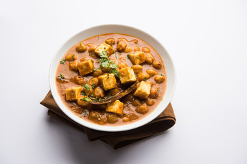 Chole Paneer curry made using boiled chickpea with cottage cheese with spices. Popular North Indian recipe. served in a bowl or serving pan. Selective focus