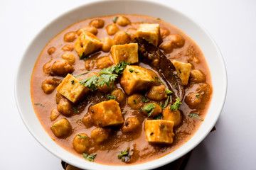 Chole Paneer curry made using boiled chickpea with cottage cheese with spices. Popular North Indian recipe. served in a bowl or serving pan. Selective focus