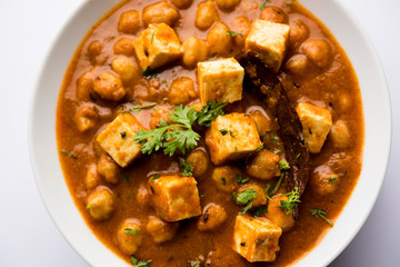 Chole Paneer curry made using boiled chickpea with cottage cheese with spices. Popular North Indian recipe. served in a bowl or serving pan. Selective focus