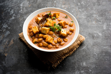 Chole Paneer curry made using boiled chickpea with cottage cheese with spices. Popular North Indian recipe. served in a bowl or serving pan. Selective focus