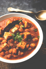 Chole Paneer curry made using boiled chickpea with cottage cheese with spices. Popular North Indian recipe. served in a bowl or serving pan. Selective focus