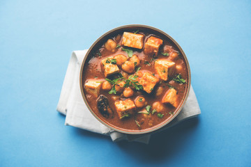 Chole Paneer curry made using boiled chickpea with cottage cheese with spices. Popular North Indian recipe. served in a bowl or serving pan. Selective focus
