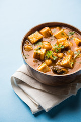 Chole Paneer curry made using boiled chickpea with cottage cheese with spices. Popular North Indian recipe. served in a bowl or serving pan. Selective focus