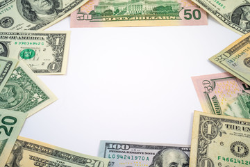 Various US Dollar bills around the edge of the image with white copy space in the center