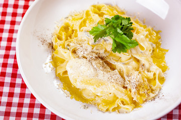 Italian Pasta with cheese on white plate. Close up
