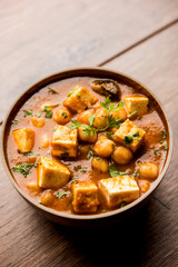 Chole Paneer curry made using boiled chickpea with cottage cheese with spices. Popular North Indian recipe. served in a bowl or serving pan. Selective focus