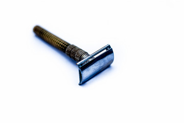 Yellow and white colored metal or steel razor isolated on white.