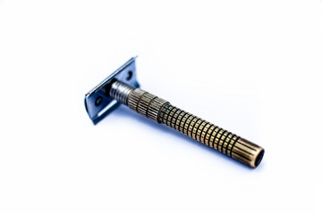 Yellow and white colored metal or steel razor isolated on white.