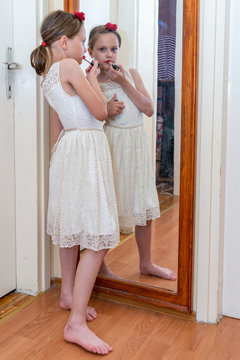 Lovely little girl making makeup