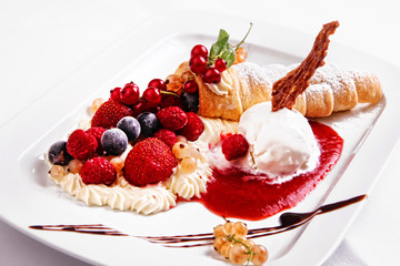 fresh cake pastry  tuck with barries on plate