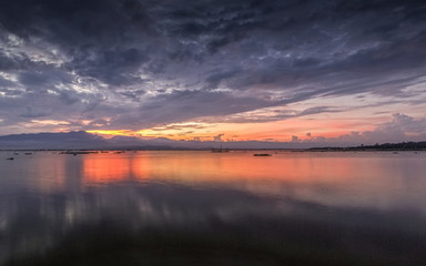 Beautiful lake view evening of cloudy sky with colorful of red light in the sky background, sunset at Kwan Phayao, Phayao Province, northern of Thailand.