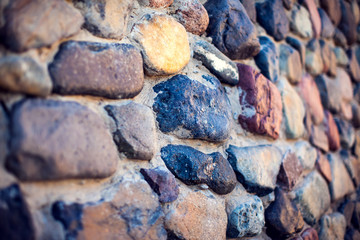 Natural colorful pebbles wall on beach in summer