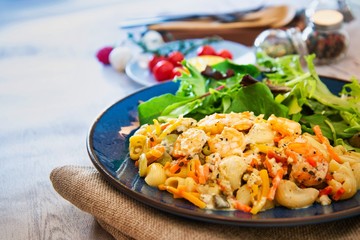 Cooked pasta with peeled shrimp, coconut milk sauce and broccoli