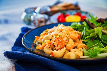 Cooked pasta with peeled shrimp, coconut milk sauce and broccoli