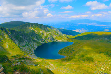 Fototapeta na wymiar Panoramic picture of a high mountain lake in a sunny day