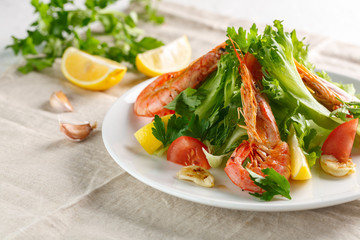fresh salad with grilled shrimps with spices and tomatoes