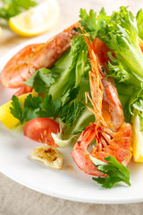 fresh salad with grilled shrimps with spices and tomatoes