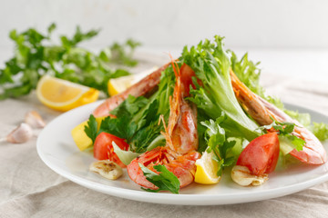 fresh salad with grilled shrimps with spices and tomatoes