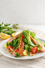 fresh salad with grilled shrimps with spices and tomatoes