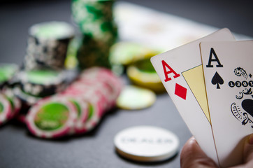 Person playing poker and looking at cards