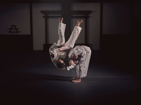 Woman practicing martial arts with man